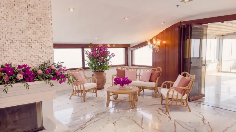 Bougainvillea concept for an adult birthday: wicker lounge seating in the fireplace corner
