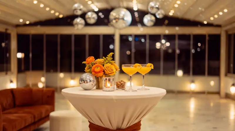 Disco concept for an adult birthday: close-up of mirror balls and a cocktail table